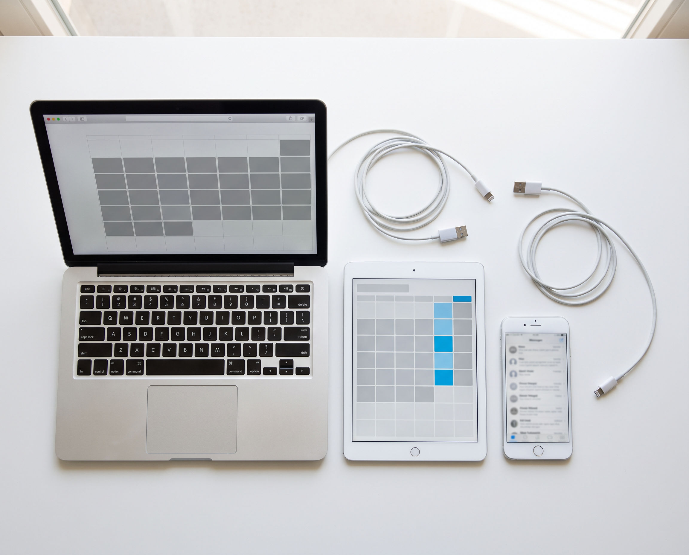 Laptop, tablet and phone each running a different app